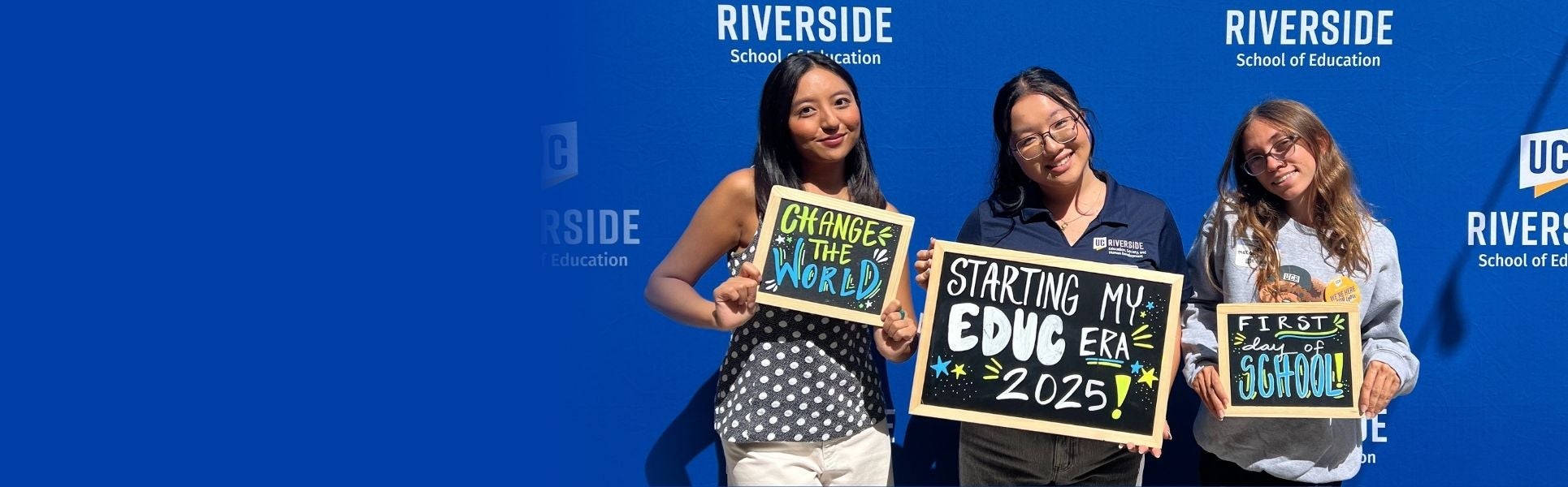 Students holding chalk boards at an event