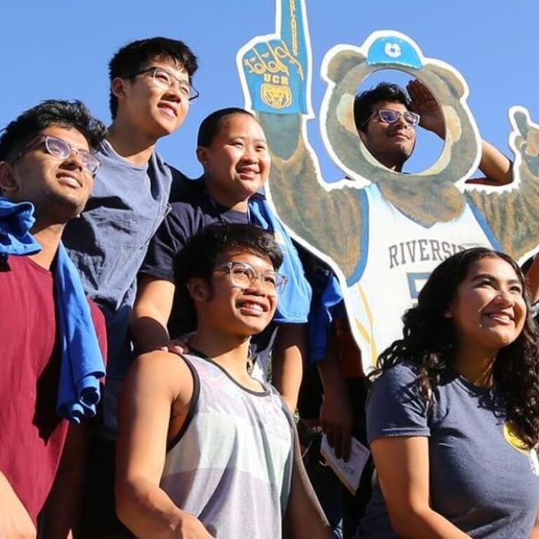 Students taking a photo in front of uc riverside belltower