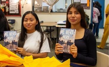 Middle Schoolers holding donated books